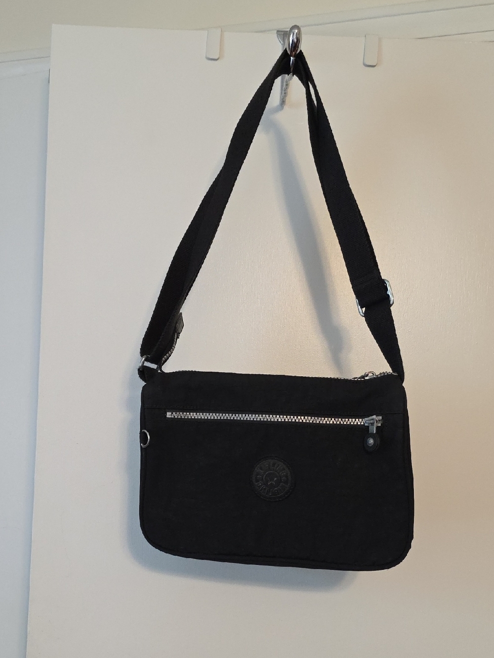 Kipling Black Crossbody with Light Beige Interior and Zip Detail